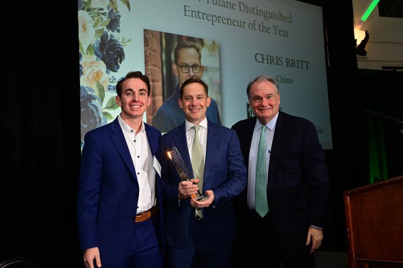 photograph, from left to right, of Clayton Britt, Chris Britt (holding the award for Tulane Distinguished Entrepreneur of the Year) and President Fitts
