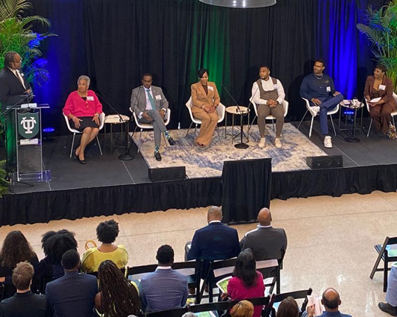 photo of Black Alumni Weekend speakers. Pictured in the photo from left to right: Erick Valentine, Stephanie Navarre (EMBA ’86), Brian Egwele (BSM ’01), Shannon Brice (MBA ’04), Derrick Strozier (BSM ’14), Kenny Welcome (BSM ’15), moderator Charisse Gibson