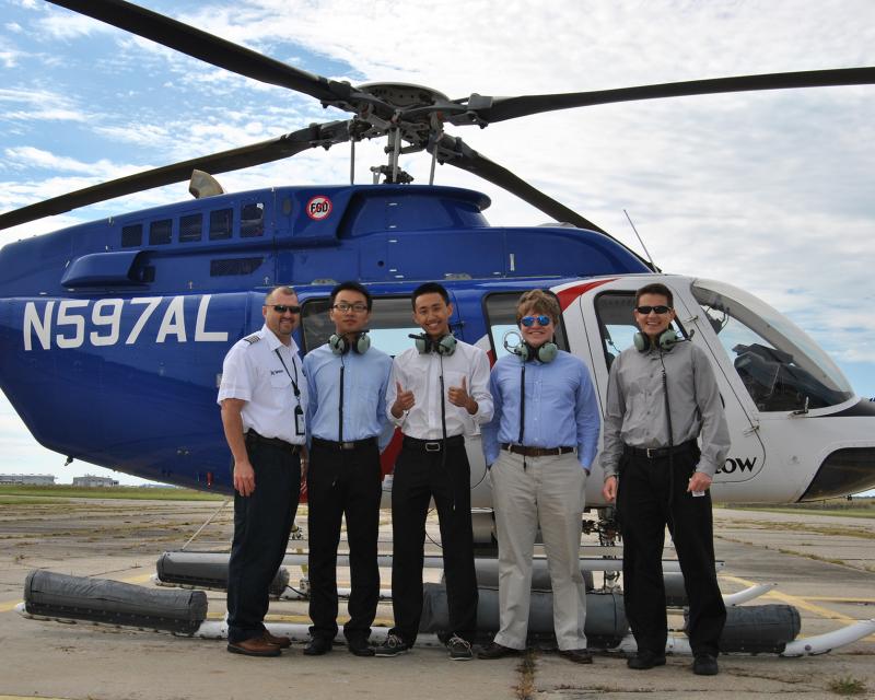 Energy students in front of helicopter