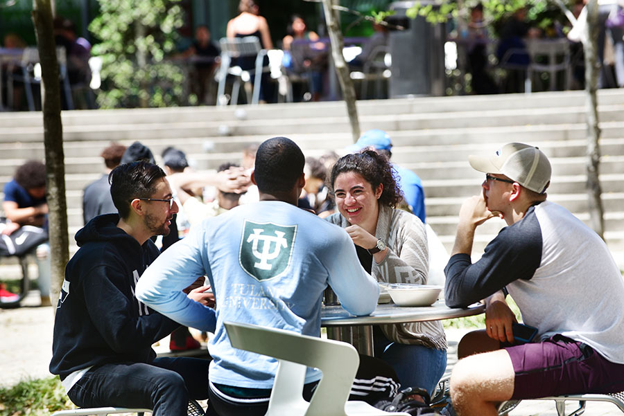 photo of students seated outside in a GWBC court yard