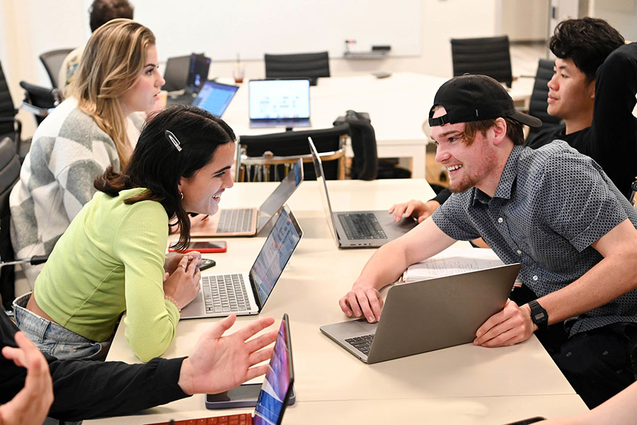 undergraduate sharing information on a laptop computer in a Freeman class