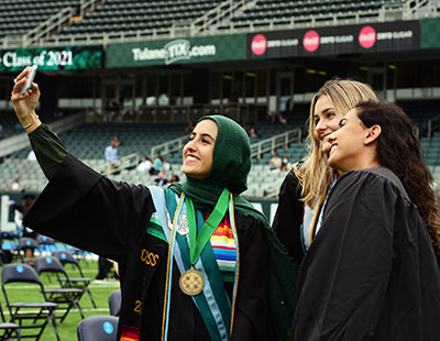 students posing for a selfie during commencement