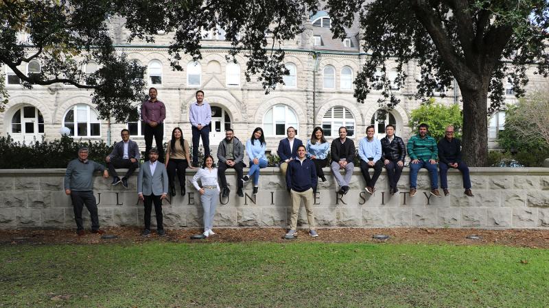 Goldring Institute for International Business students seated on a Tulane campus structure in 2025.