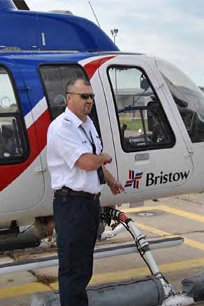 man standing next to helicopter