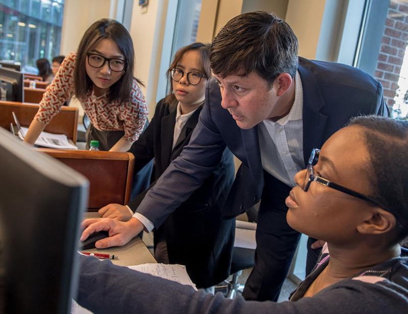 Students and faculty member in trading room