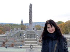 A student poses in front of Eiffel Tower in Paris