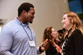 Group of professionals engaging in a discussion during an international business event.