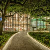 The Goldring/Woldenberg Business Complex at night with the approach walk way lit up.