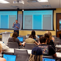 Jeff Salyers, sports management professor for the Freeman School of Business, presenting to a classroom of students.