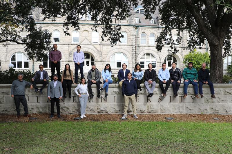 Goldring Institute for International Business students seated on a Tulane campus structure in 2025.