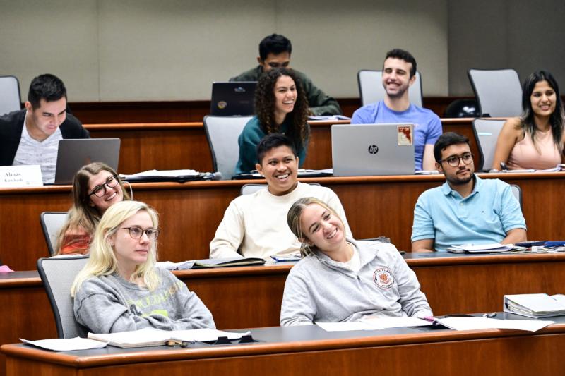 MBA students in a GWBC classroom smiling and laughing.