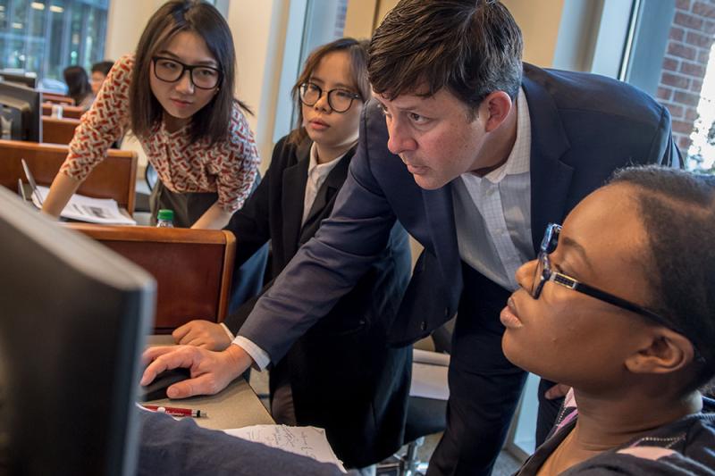 Students and faculty member in trading room