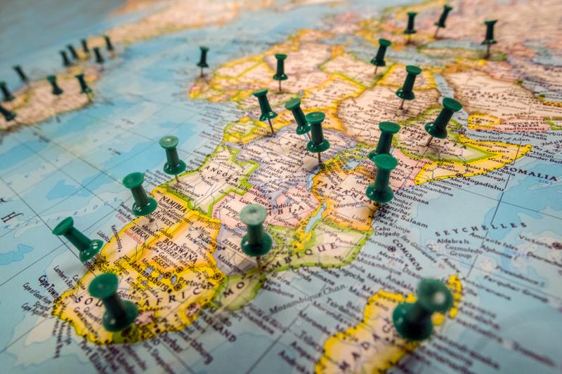 image of a world map with thumb tacks in it