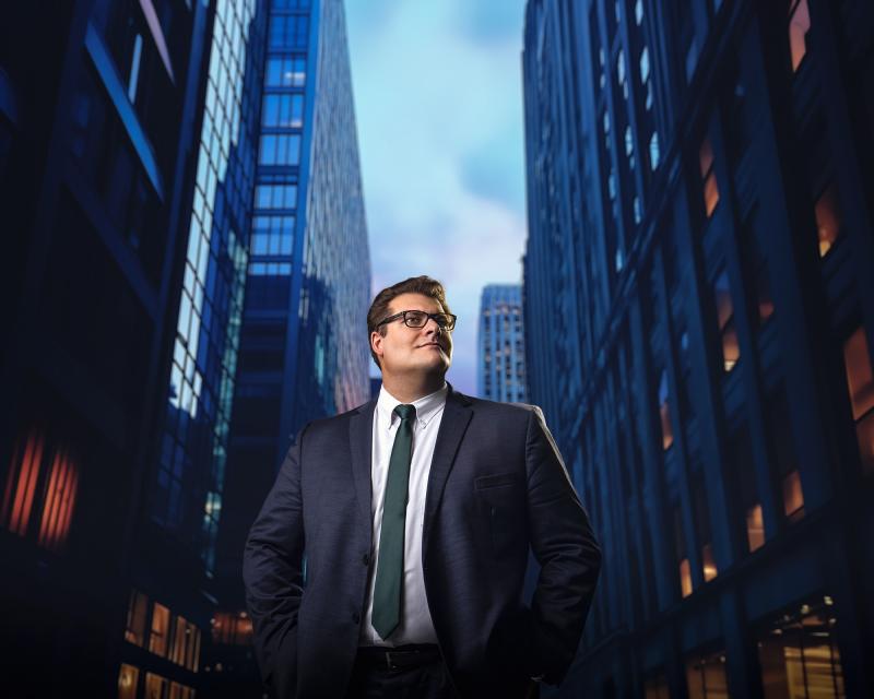 Freeman student posing in front of the New Orleans Central Business District.