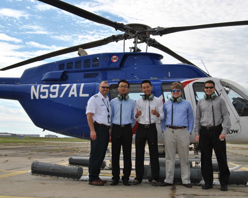Energy students in front of helicopter