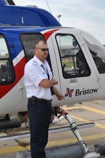 man standing next to helicopter