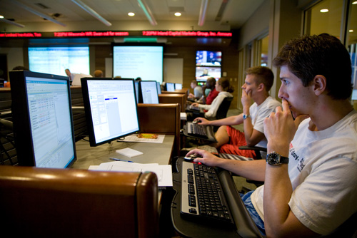 Students work at computers in the mock trading room.