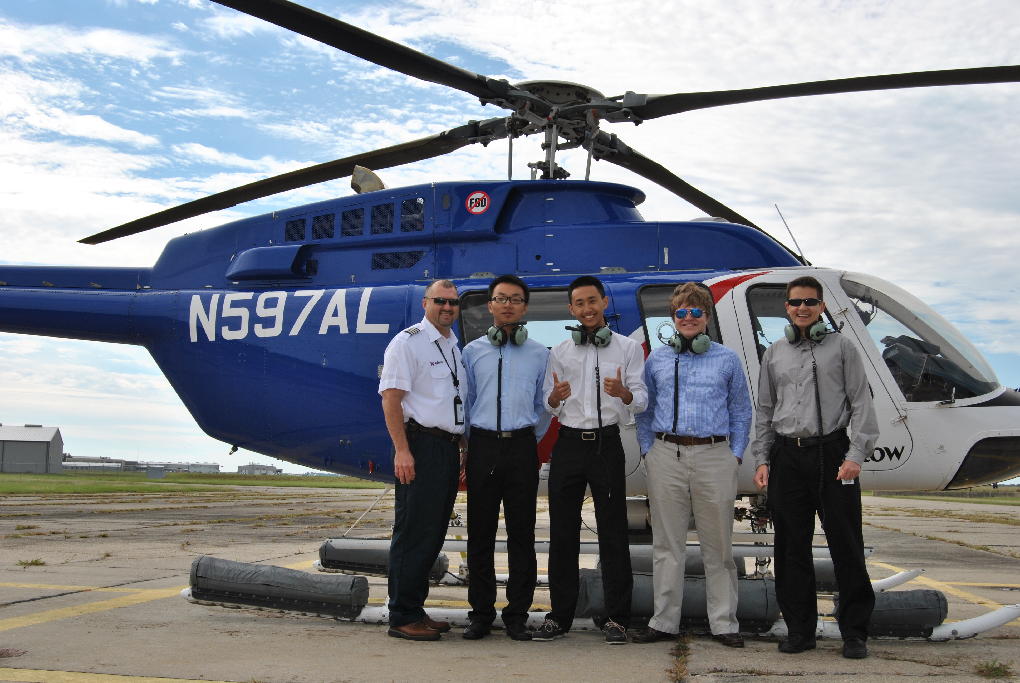 Energy students in front of helicopter